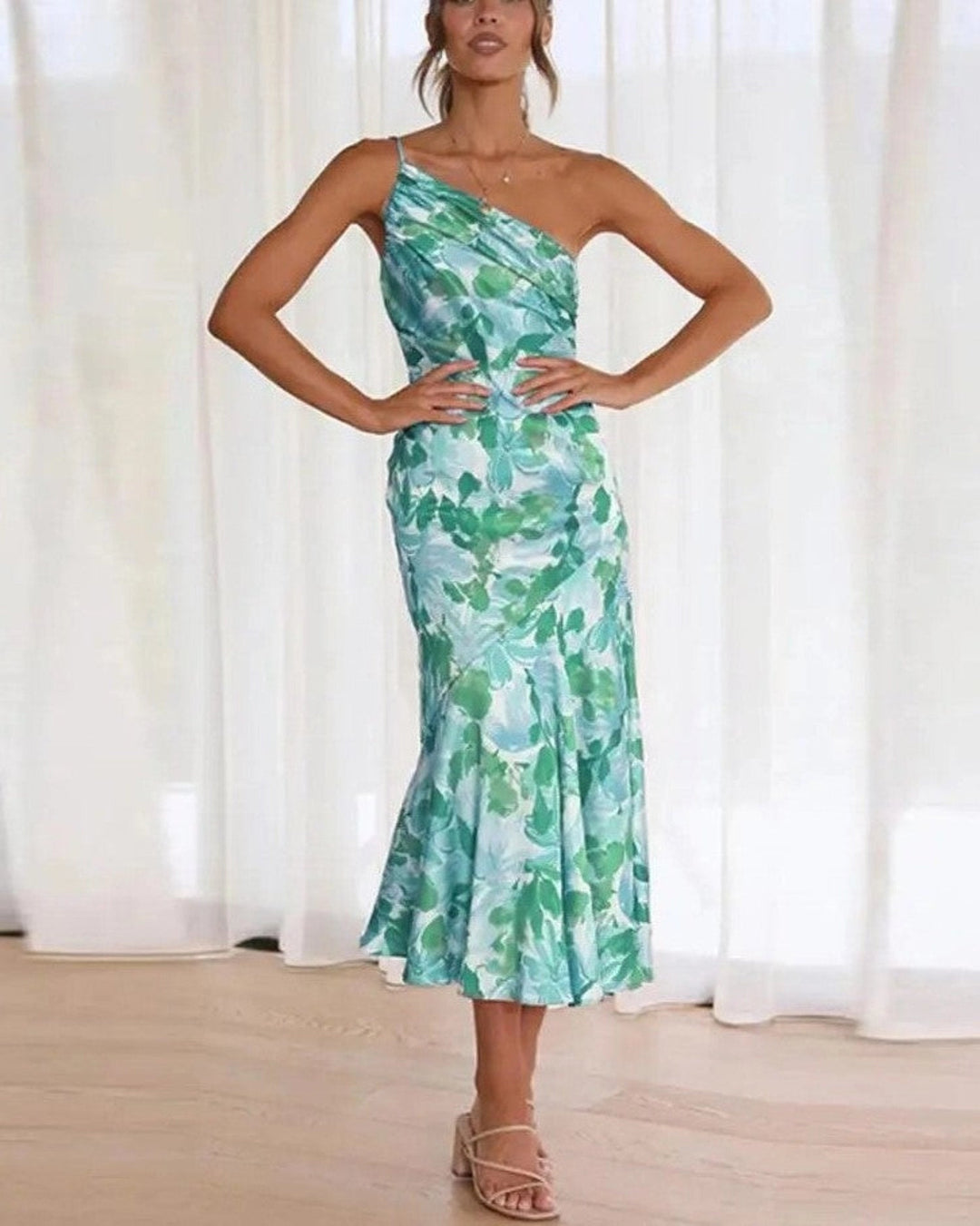 Summer chic: women's floral midi dress, sleeveless, vibrant colors, and flowing asymmetric hem.
