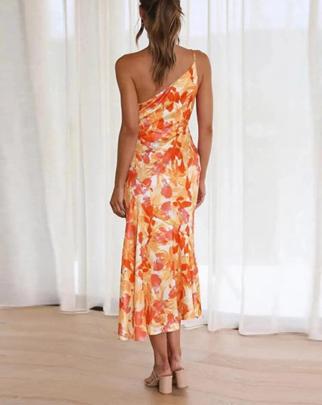 Women's elegant floral asymmetric midi dress with a sleeveless cut and flattering flowing hem.