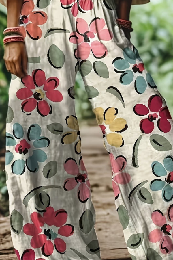 Women's elegant floral cropped pants with a vibrant pink and blue pattern.