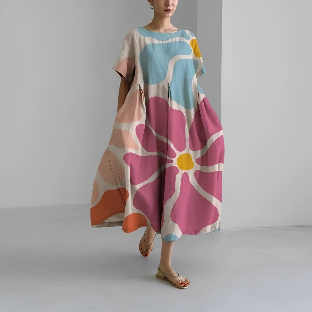 Chic women's maxi dress with a vibrant, colorful floral pattern, ideal for stylish summer fashion.