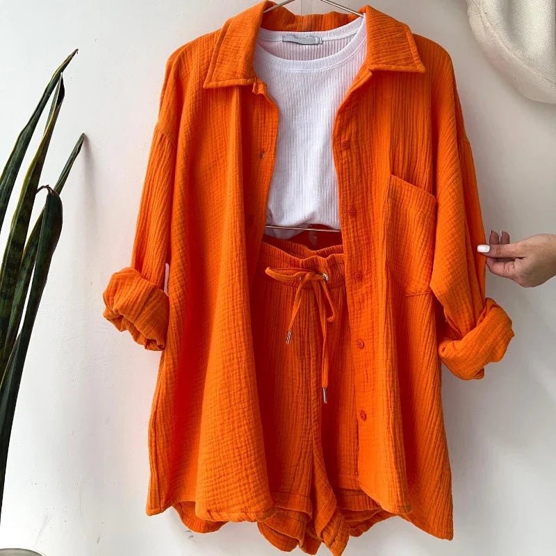Women's vibrant orange flare two-piece suit for effortless summer style.