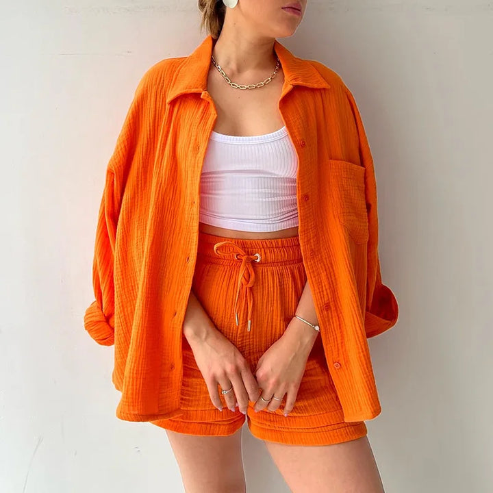 Relaxed fit vibrant orange two-piece suit, comfortable women's summer attire.