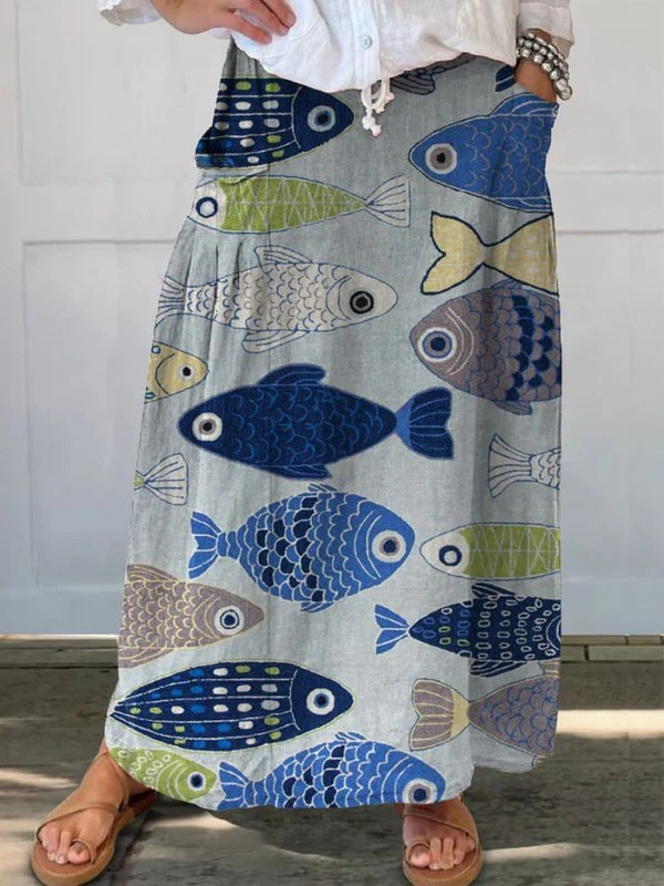 Women's vintage blue A-line skirt with whimsical fish art print & pockets, perfect for casual summer wear.