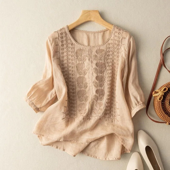 Women's vintage embroidered blouse with elegant sheer puff sleeves and a round neck, perfect for spring.