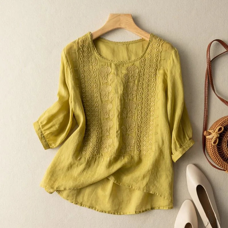 Women's blouse featuring stylish sheer puff three-quarter sleeves and intricate vintage embroidery, round neck.