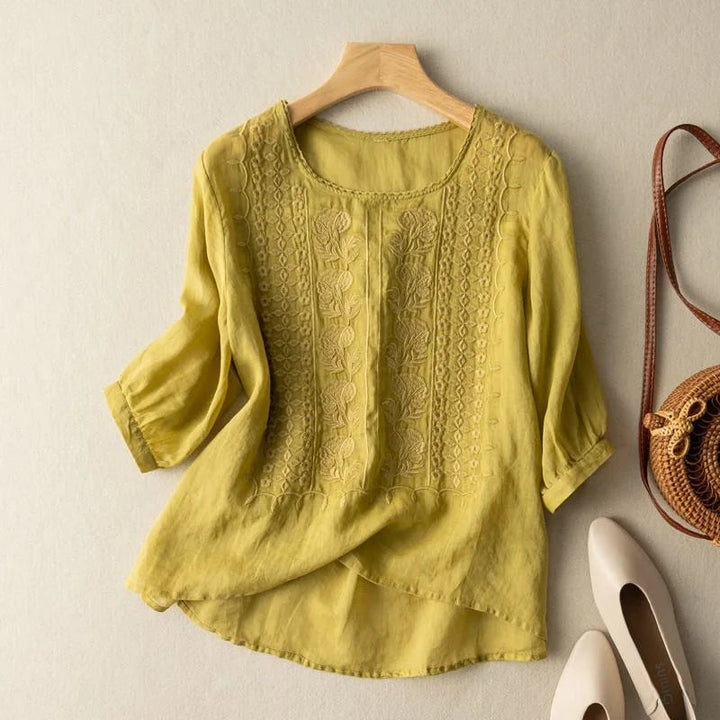 Women's blouse featuring stylish sheer puff three-quarter sleeves and intricate vintage embroidery, round neck.