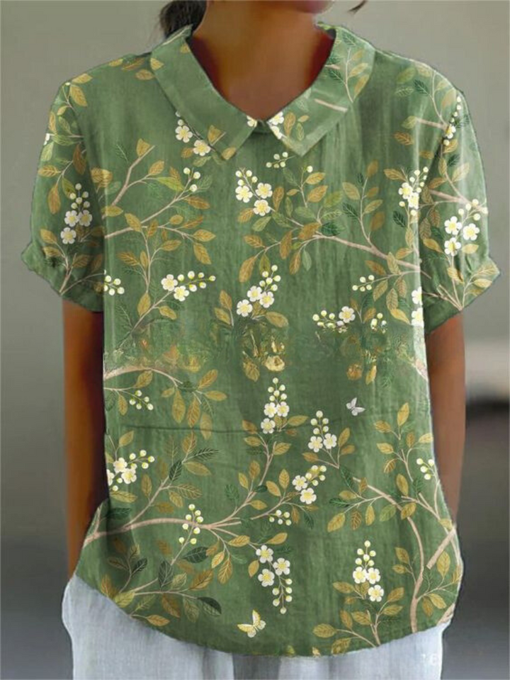 Stylish women's collared short sleeve top showcasing a delicate vintage floral pattern, great for spring fashion.