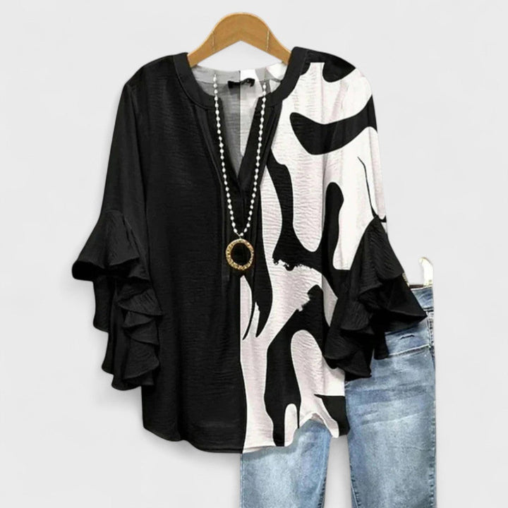 Close-up: Women's vintage floral V-neck blouse, showcasing intricate print and graceful ruffle sleeves.