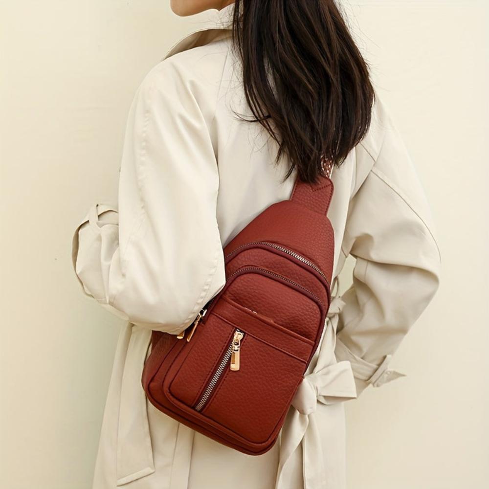 Woman wearing a khaki vintage leather chest crossbody bag, stylish daily carry accessory for women.