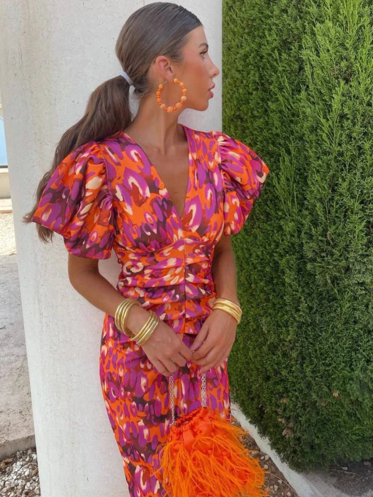 Flattering women's ruched midi dress, vibrant abstract print. Elegant cocktail & evening wear for women.