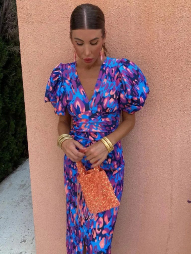 Eye-catching abstract print midi dress for women. Stylish ruched design, perfect for evening occasions.