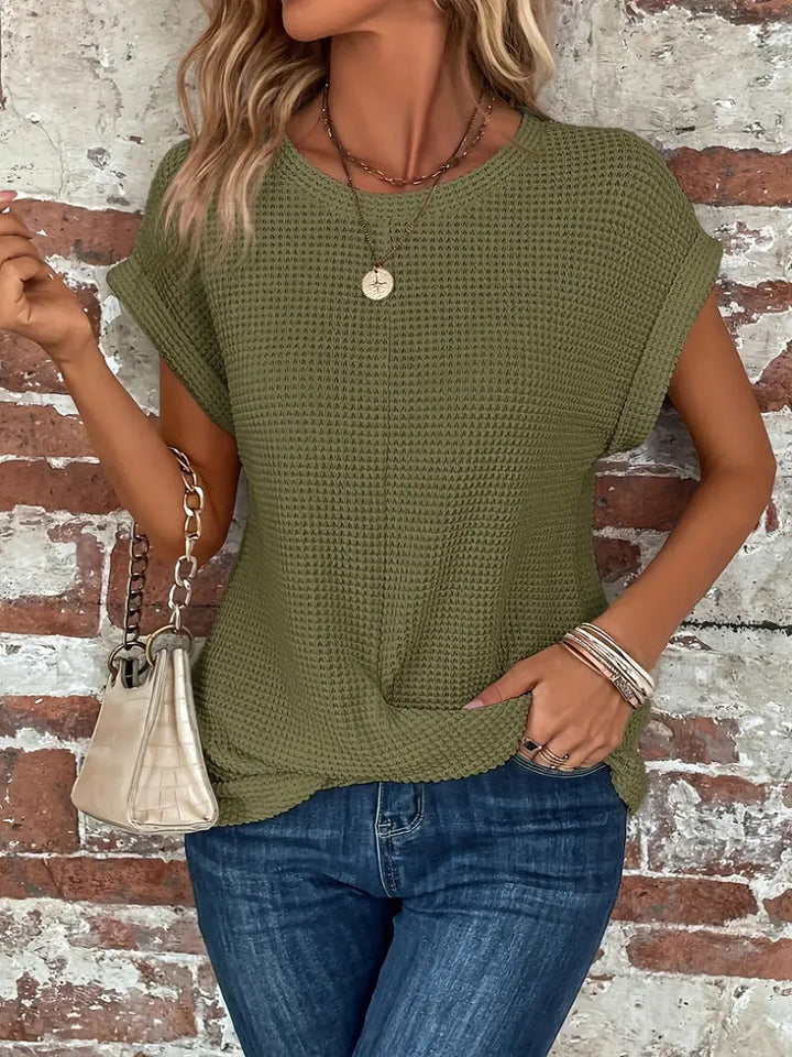 Relaxed fit women's waffle knit tee with twist front detail. Comfortable short sleeve top for everyday wear.