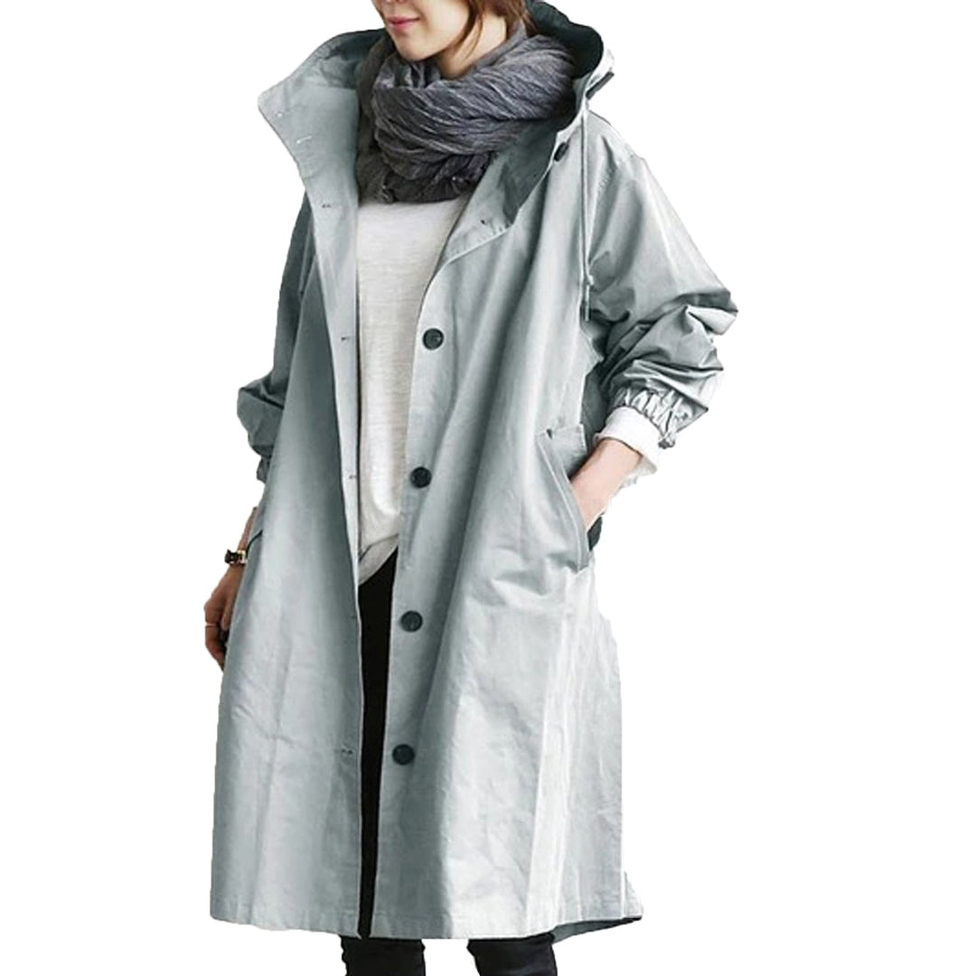 Modern women's long rain jacket, designed for casual style and ultimate waterproof outdoor protection.