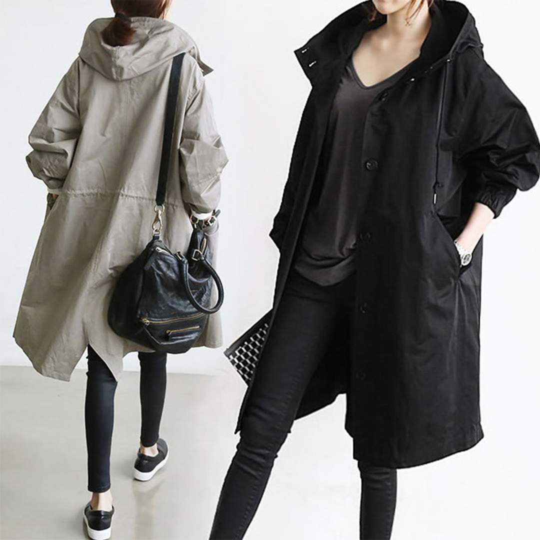 Durable women's long trench raincoat, providing waterproof performance and a chic casual outdoor look.