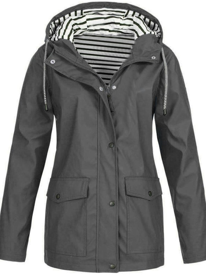 Lightweight women's travel jacket. Waterproof, windproof, with a practical hood & secure pockets for adventures.