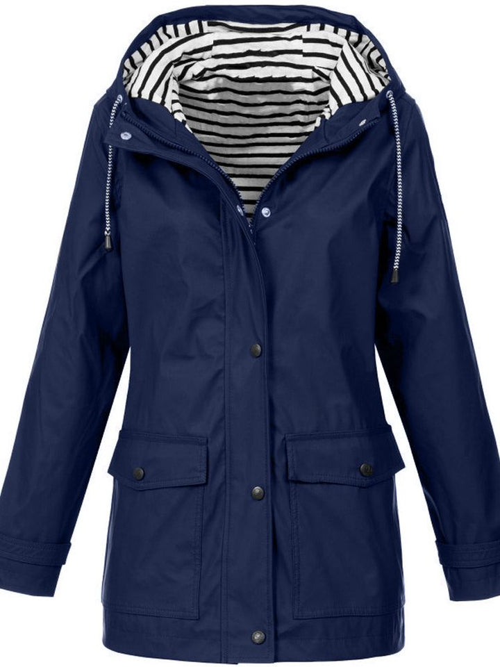 Front view of a women's casual waterproof hooded jacket with functional pockets, ready for any outdoor activity.