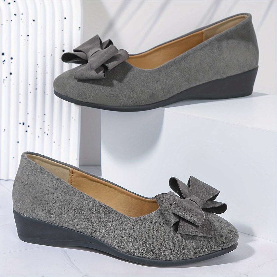 Women's casual slip-on wedge flats with bow accent, comfortable and stylish for versatile occasions.