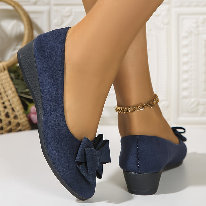 Comfortable women's slip-on wedge flats with a bow, round toe, ideal for walking and casual outings.