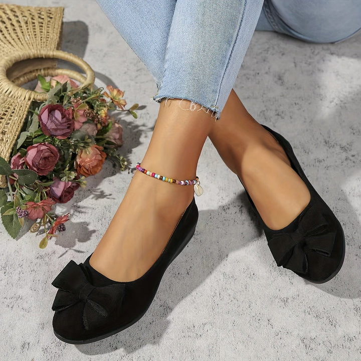 Women's elegant round toe slip-on wedge flats with a bow, offering versatile and stylish footwear.
