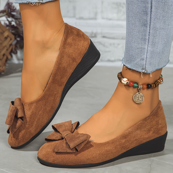 Women's walking wedge flats with a charming bow, round toe, and easy slip-on comfort for daily use.