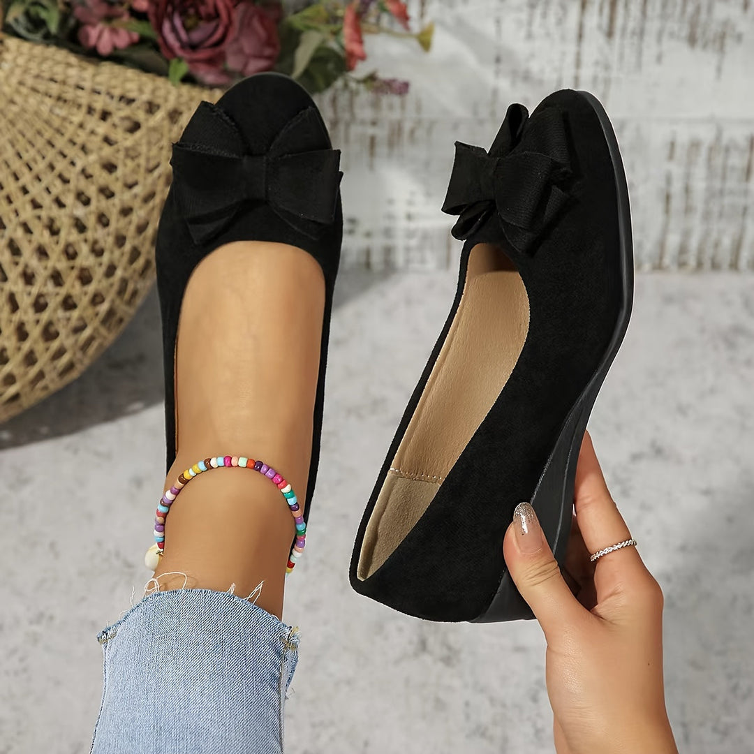 Classic women's wedge flats, round toe, bow-accented slip-on, offering comfortable ladies footwear.