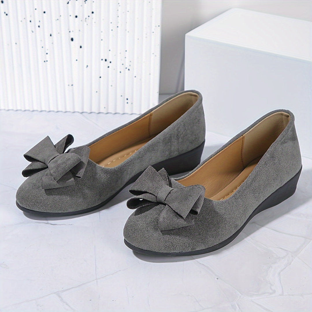 Stylish women's wedge ballet flats, round toe, bow detail, providing all-day comfort and elegance.