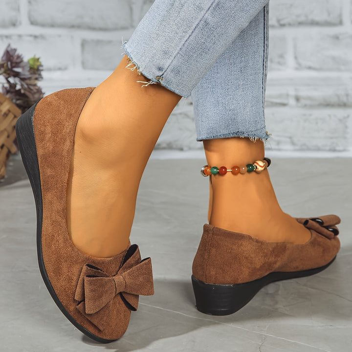 Elegant women's wedge ballet flats with a subtle bow, round toe, and easy slip-on design for office.