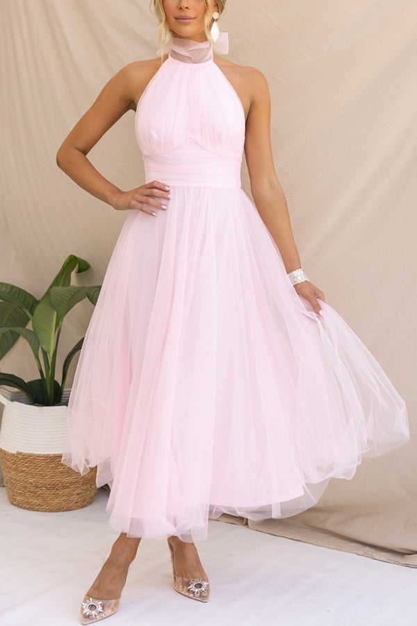 Close-up of the delicate layered tulle fabric on a whimsical midi dress for women.