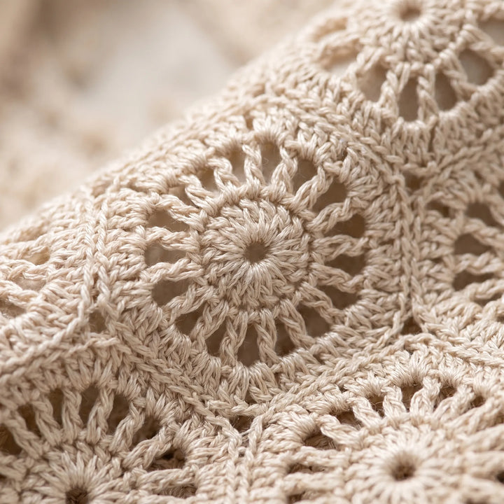 White women's breathable crochet sleeveless crop top, relaxed Bohemian fit for stylish summer casual wear.