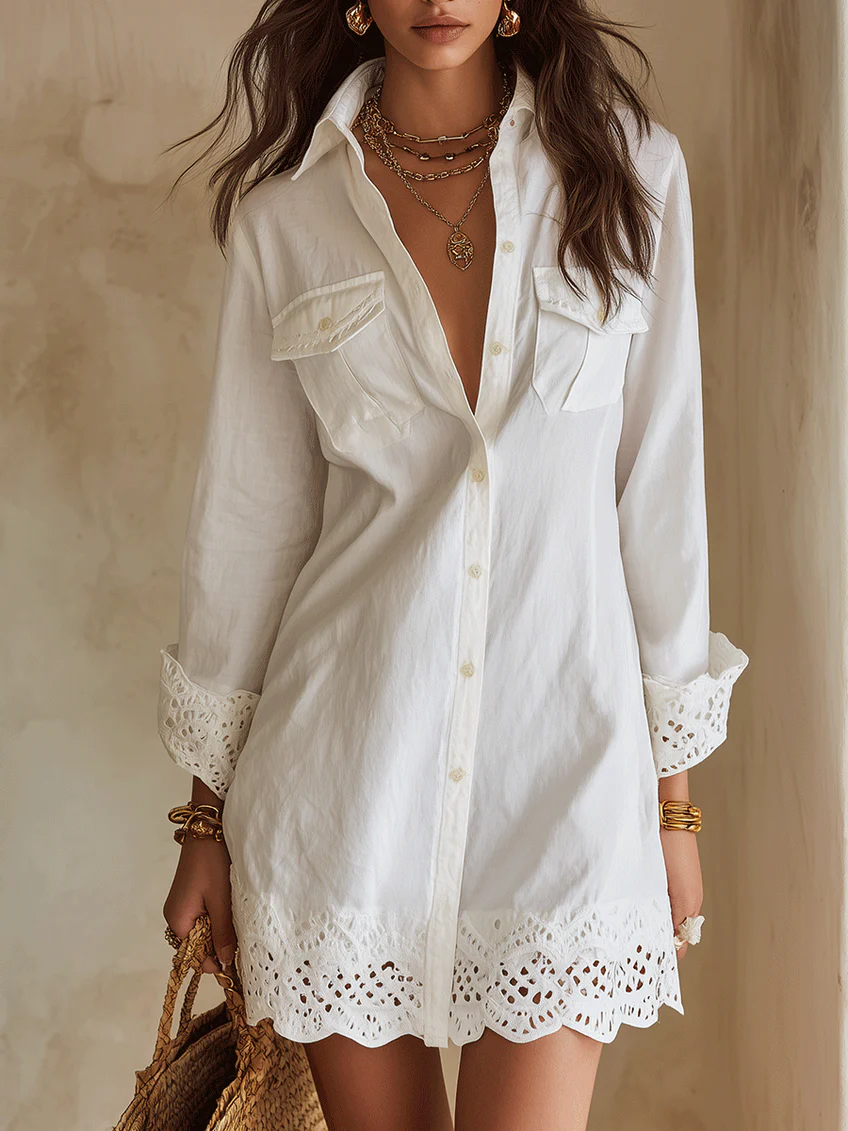 Women's white collared button-front shirt dress with long sleeves and delicate crochet hem, perfect for summer.