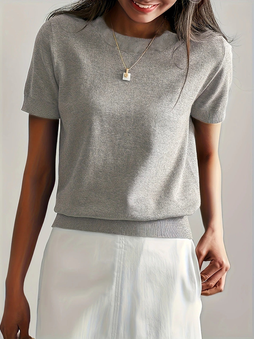 Pink women's versatile crew neck ribbed short sleeve tee, perfect for warm weather.