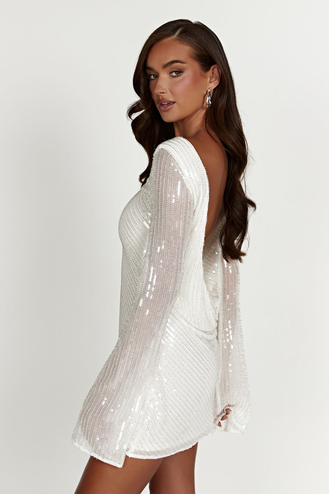 Luxurious white sequin fabric of a mini dress, offering a dazzling & high-quality party look.