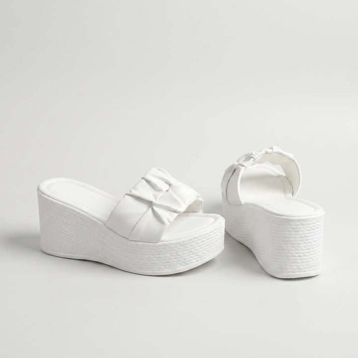 Chunky white women's slip-on platform wedge sandals with an open toe, ideal for warm weather comfort.