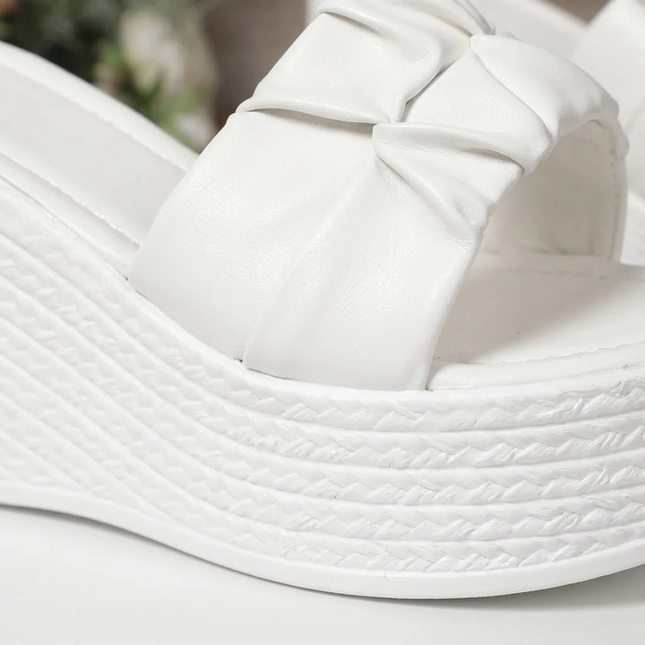 Comfortable white women's slip-on wedge sandals with open toe, great for summer vacations & casual ease.