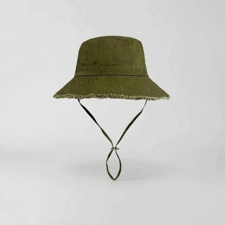 Women's versatile wide brim bucket hat in pink, ideal for sun protection on beach trips.
