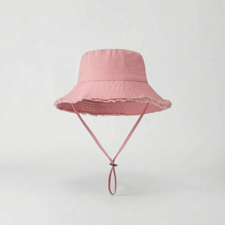 Elegant white wide brim bucket hat for women, essential for stylish sun protection outdoors.