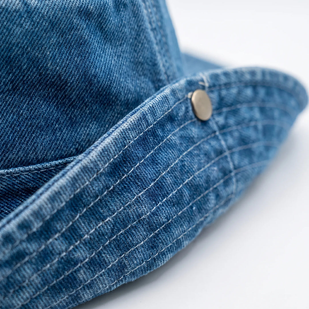 Portable women's adjustable wide brim bucket hat, offering stylish shade for travel, beach, & outdoor activities.