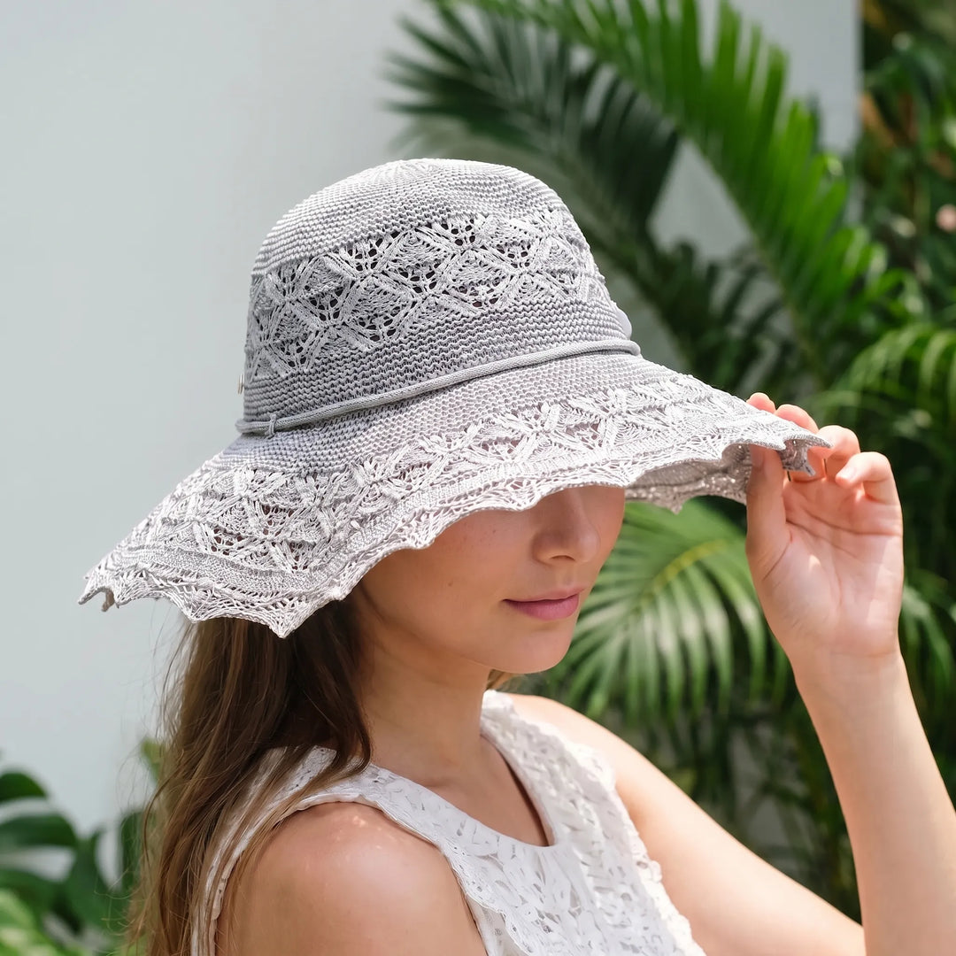Women's wide brim sun hat, foldable for travel, offering stylish sun protection for beach or vacation.