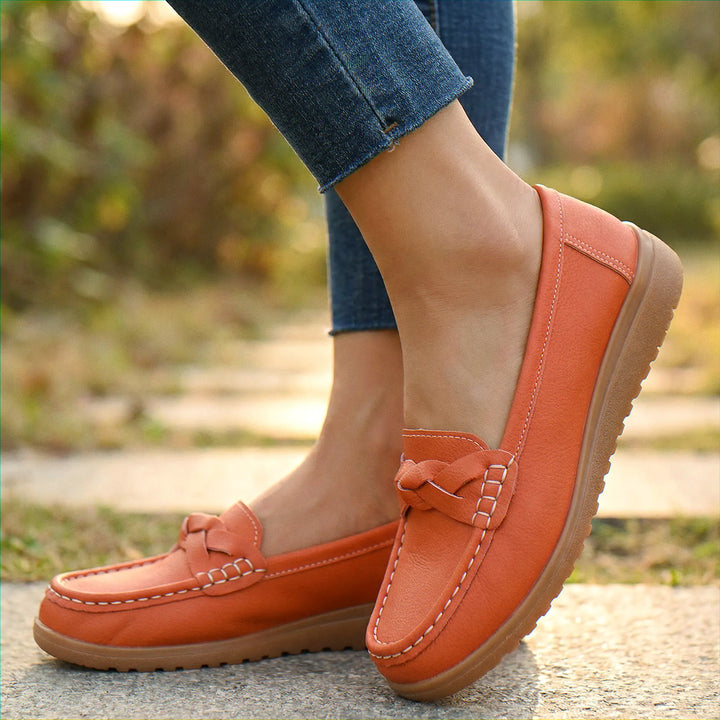 Stylish wide fit women's loafers with integrated arch support for effective pain relief.