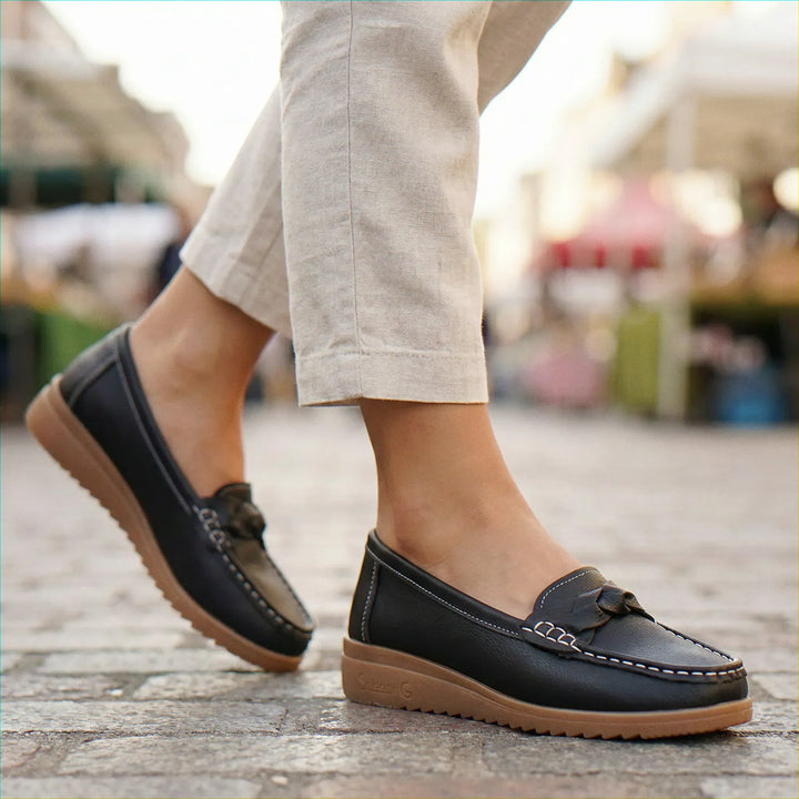 Black leather wide fit women's loafers, featuring essential arch support for healthy feet.