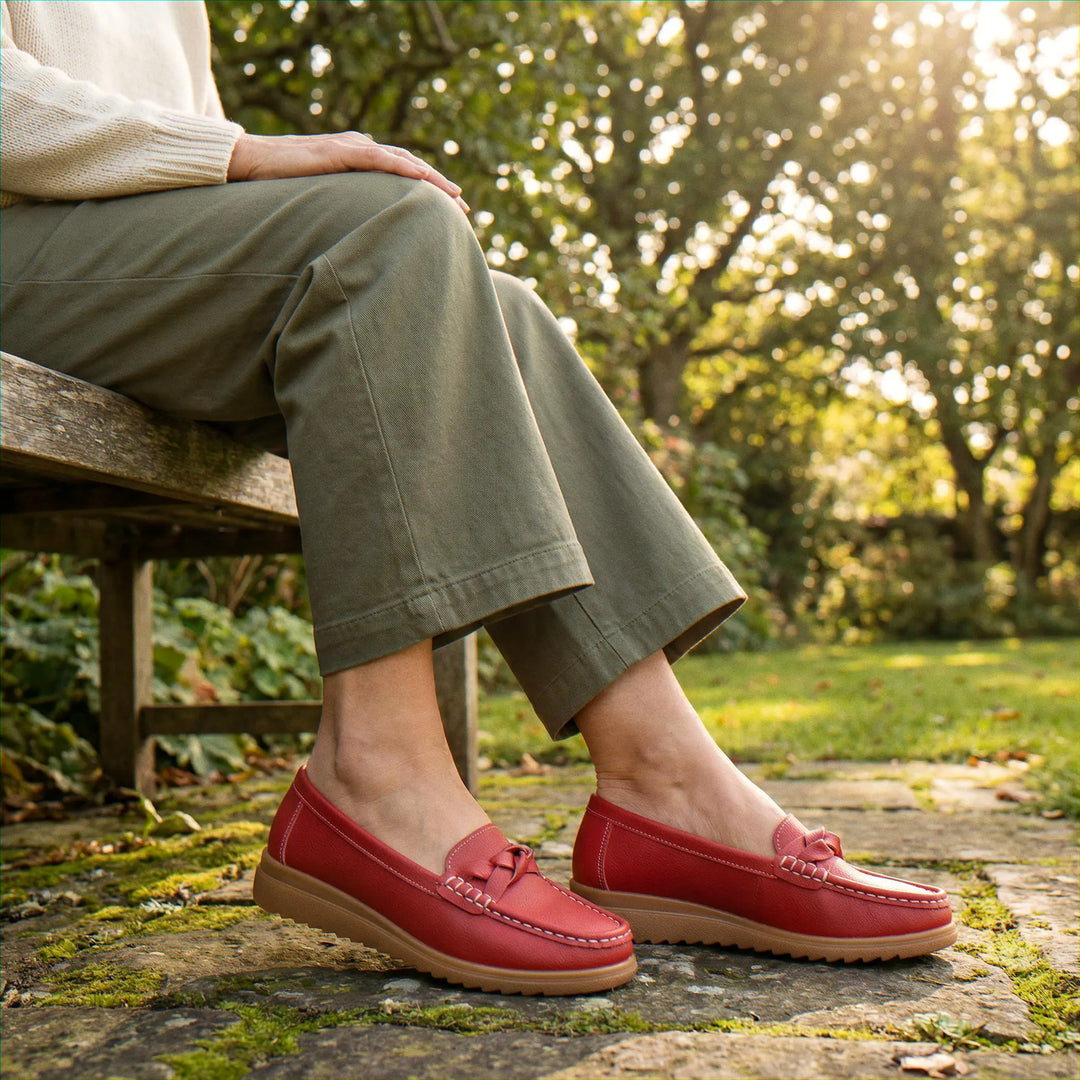 Women's black wide fit orthopedic slip-on loafers, designed for superior arch support.
