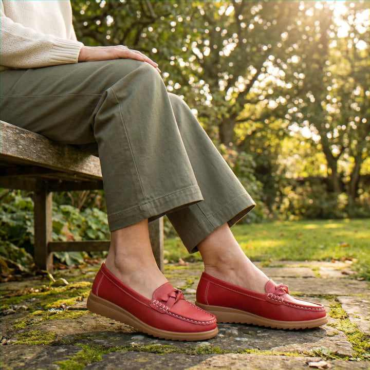 Women's black wide fit orthopedic slip-on loafers, designed for superior arch support.