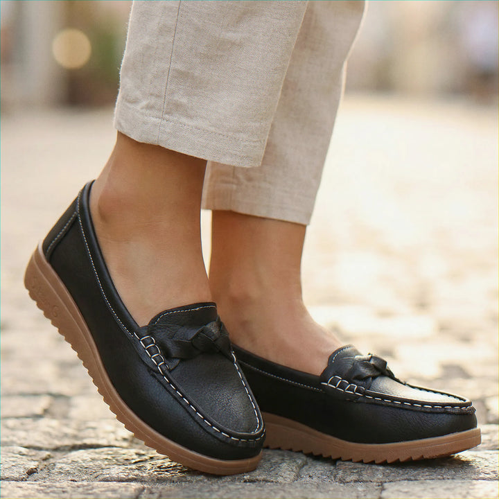 Top-down view of black women's wide fit slip-on orthopedic loafers.