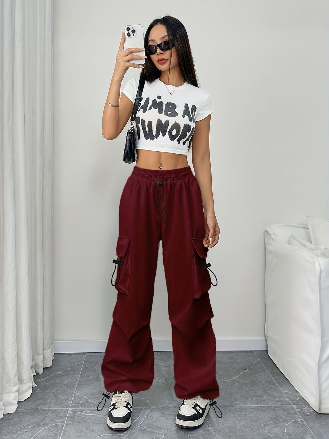 Front view of women's fashion wide leg cargo pants, showcasing the adjustable drawstring waist and side pockets.