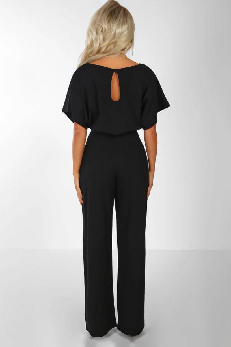 Women's belted wide-leg jumpsuit with batwing sleeves. Chic, elegant wear for various occasions. Effortless fashion.