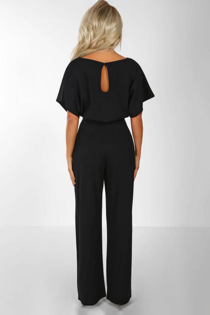 Women's belted wide-leg jumpsuit with batwing sleeves. Chic, elegant wear for various occasions. Effortless fashion.