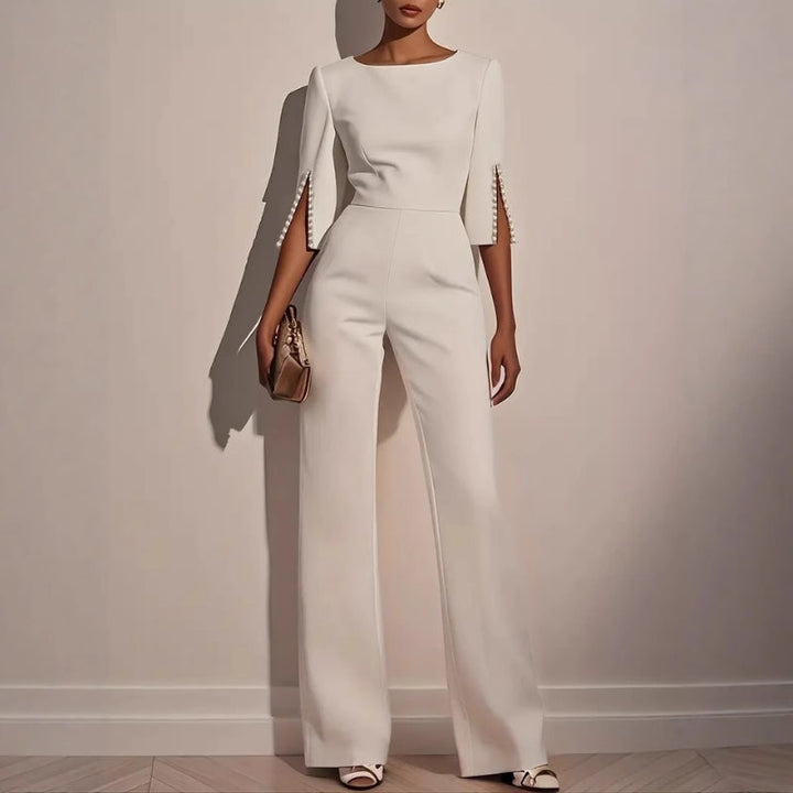 Women's wide leg jumpsuit with elegant pearl detail on sleeves, perfect for chic spring & summer fashion.