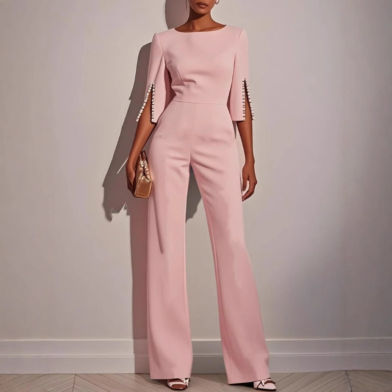 Sophisticated women's wide leg jumpsuit showcasing delicate pearl-detailed sleeves, for modern elegance.
