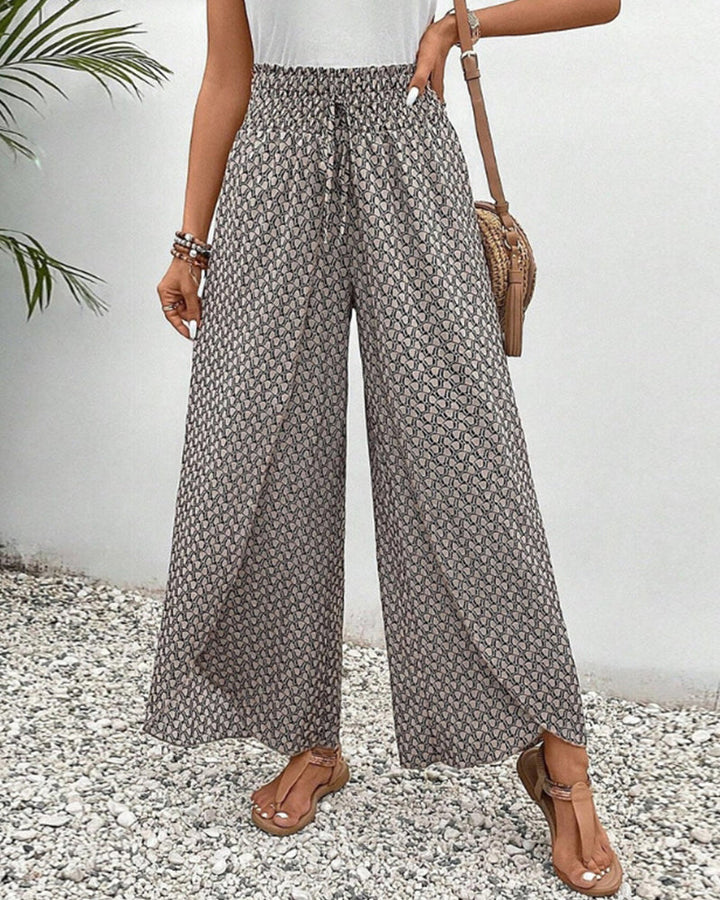 Women's wide leg trousers with a relaxed fit and striking geometric print. Stylish & comfortable fashion pants.