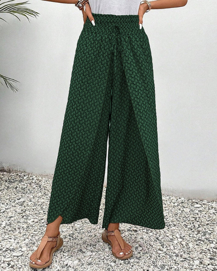 Full-length view of women's wide leg trousers. Relaxed fit, vibrant geometric print for a stylish look.